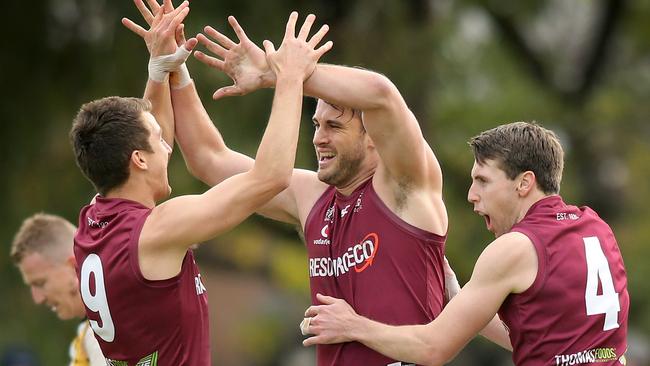 Jack Trengove (left) celebrates a goal with Prince Alfred Old Collegians teammates Tomas Spanovskis and Craig Pitt. Picture: Dean Martin