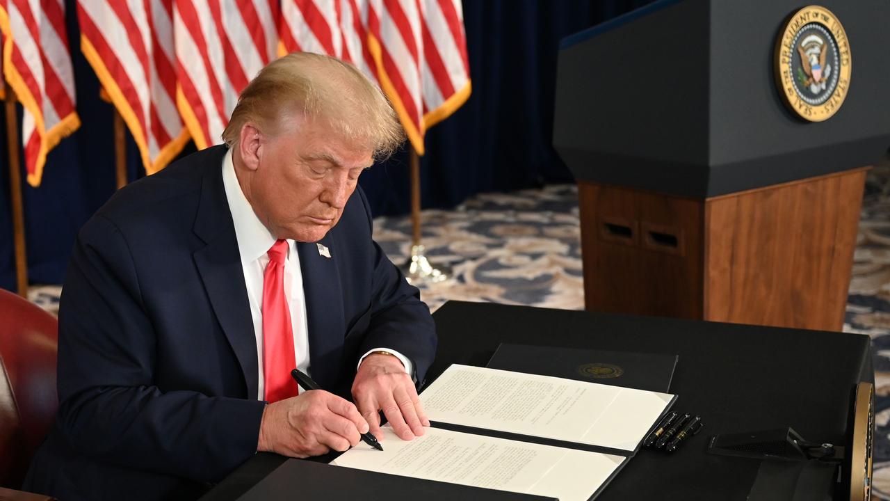 US President Donald Trump signs executive orders extending coronavirus economic relief, during a news conference in Bedminster, New Jersey, on August 8, 2020. Picture: Jim Watson / AFP