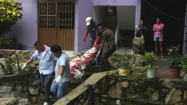 In this August 29, 2017 photo, a body wrapped in a bloodstained sheet is removed from an apartment building where a woman and two men were executed, in the Alta Progreso neighbourhood of Acapulco, Mexico. Picture: AP/Bernandino Hernandez