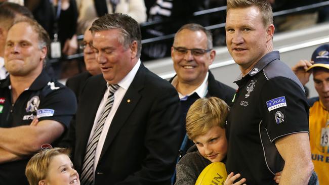 Collingwood coach Nathan Buckley gets a hug from son Jett while Ayce Buckley chats to Eddie McGuire. Picture: Michael Klein