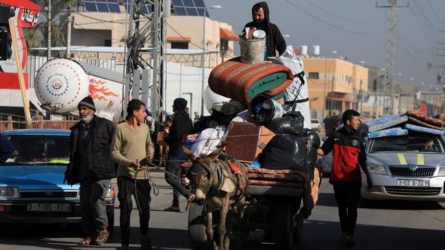 Palestinians flee their homes after they were ordered by the Israeli army to evacuate the area, in Bureij in the central Gaza Strip on Tuesday. Picture: Reuters