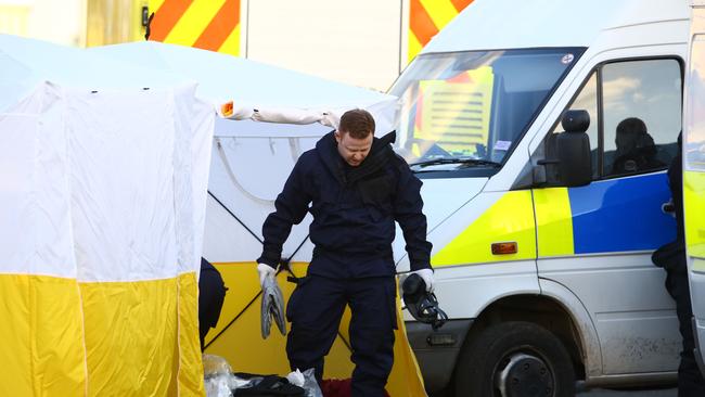 Police officers work at the Ashley Wood vehicle recovery centre in Salisbury where Sergei Skripal’s the car was taken. Picture: AFP.