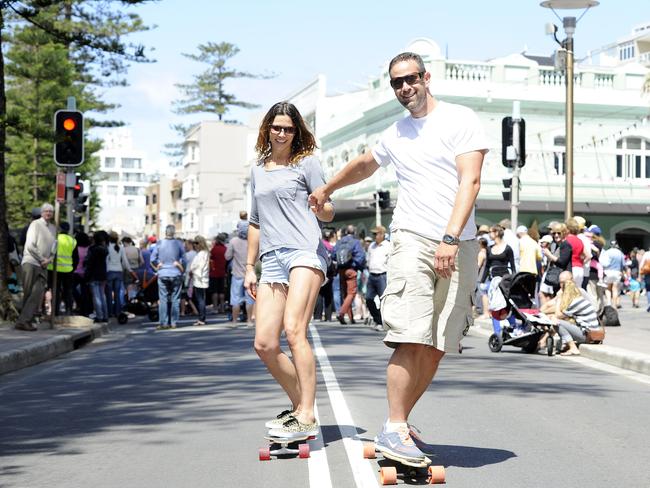 Jasmine Brown and Andy Simmons from Manly skating down the street at the Manly Jazz festival in 2013. Picture: David Swift.