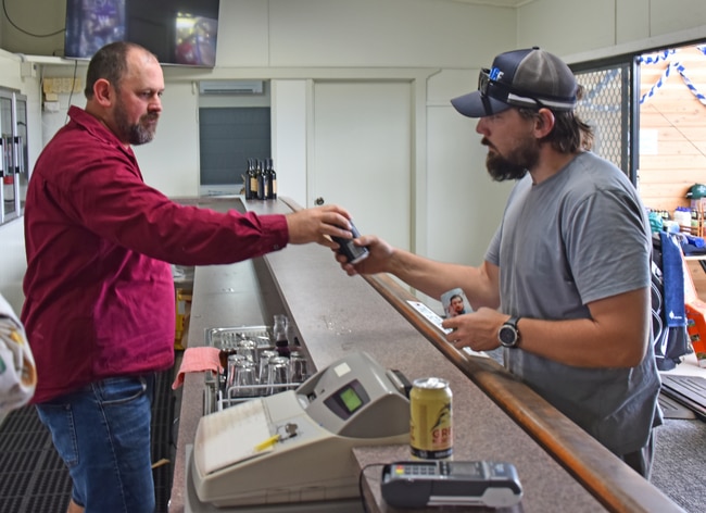 Former Texas senior constable, Jordan Barber (left), working behind the bar for the event with Senior Constable Rhys Bennett (right). Picture: Supplied.