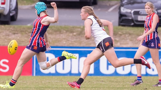 Wilston Grange players with blue headgear Sophia Allen goes for goal.