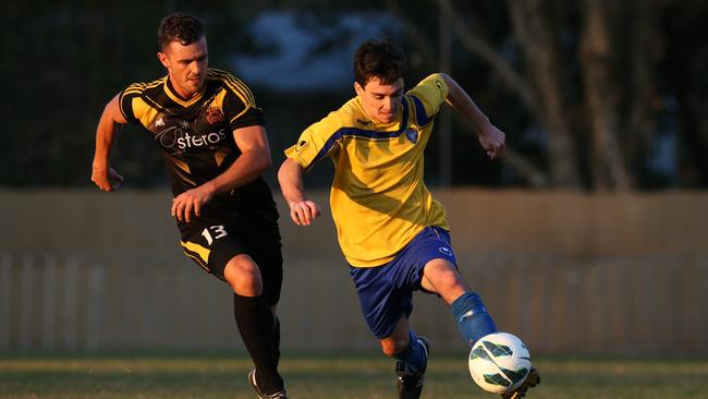 Gold Coast Premier League soccer grand final between Broadbeach and Mudgeeraba, held at Jim Devine Field, Murwillumbah. Mudgeeraba's Matt Harris and Broadbeach's Tom Boland.