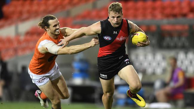 Jake Stringer fends off the tackle from Phil Davis. Picture: AFL Photos/via Getty Images