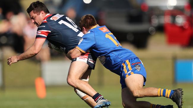 Jake Scott of the Rams is tackled. (Photo by Jeremy Ng/Newscorp)