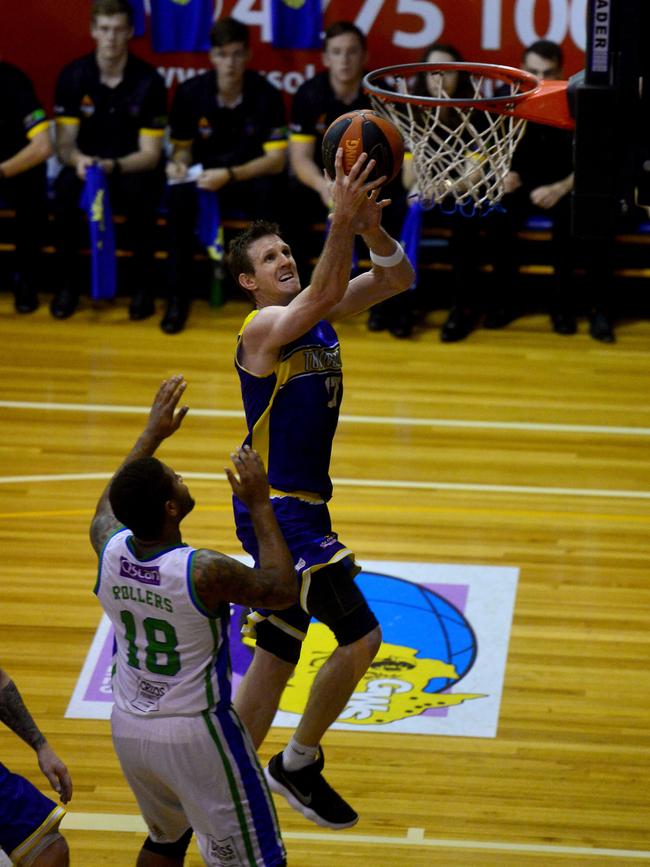 Queensland Basketball League quarter finals at Townsville Basketball Stadium. Townsville Heat against Gold Coast Rollers. Rollers' Deon Mitchell and Heat's Peter Crawford. Picture: Evan Morgan