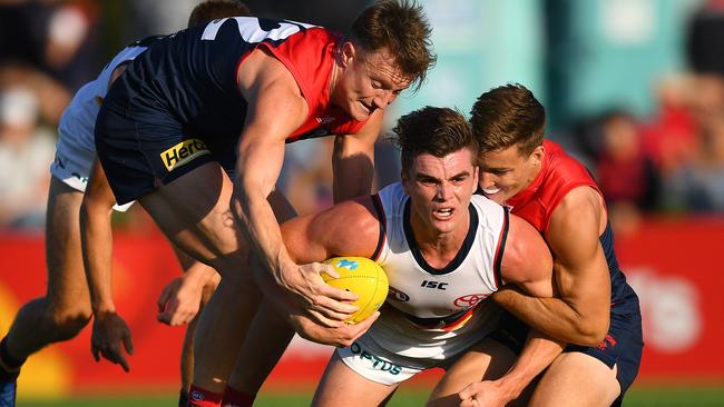 Aaron vandenBerg tries to wrench the ball from Adelaide’s Ben Keays during Saturday’s Marsh Series fixture.