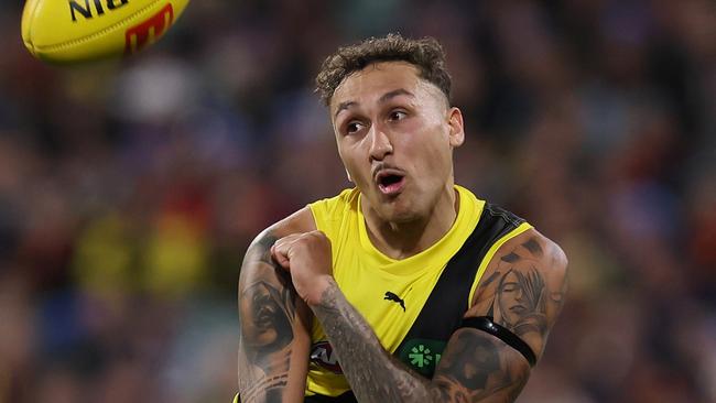 ADELAIDE, AUSTRALIA - JUNE 06: Shai Bolton of the Tigers handpasses the ball away from Mitchell Hinge of the Crows during the 2024 AFL Round 13 match between the Adelaide Crows and the Richmond Tigers at Adelaide Oval on June 06, 2024 in Adelaide, Australia. (Photo by James Elsby/AFL Photos via Getty Images)