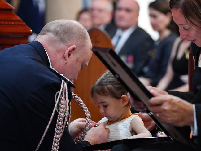 Charlotte O'Dwyer receives her fathers service medal from RFS Commissioner Shane Fitzsimmons. Picture: AAP