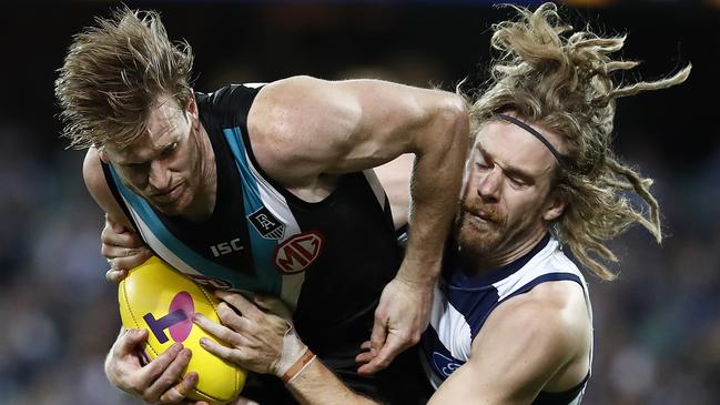 Tom Jonas and Cam Guthrie clash during last year’s qualifying final between Port Adelaide and Geelong at Adelaide Oval. Picture: Ryan Pierse/Getty Images