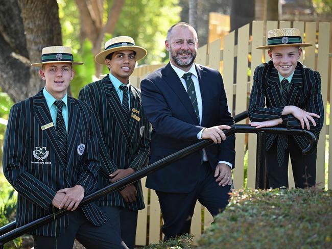 Brisbane Boys’ College headmaster Andre Casson with Year 9 students (from left) Andre Venter, Shanuka Silva and Jacob Bardell. Picture: Lyndon Mechielsen