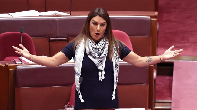 Australian Independent Senator Lidia Thorpe wears a Palestinian keffiyeh scarf as she speaks in the Senate chamber at Parliament House in Canberra on October 16, 2023. (Photo by DAVID GRAY / AFP)