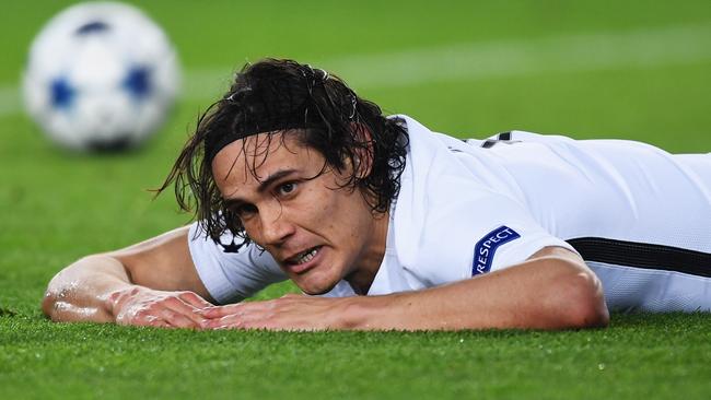 Edinson Cavani of PSG reacts as his shot hits the post.