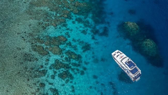 Aerial of Divers Den's AquaQuest boat on the Great Barrier Reef. Photo: TTNQ