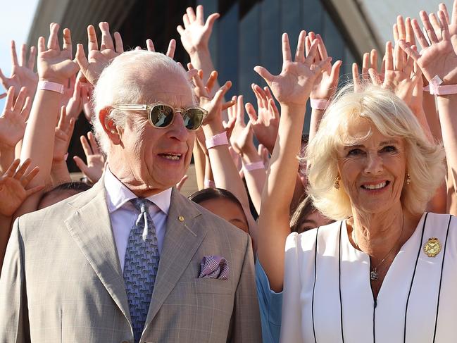 SYDNEY, AUSTRALIA - OCTOBER 22: King Charles III and Queen Camilla pose for a photo with students at the Sydney Opera House on October 22, 2024 in Sydney, Australia. The King's visit to Australia is his first as monarch, and the Commonwealth Heads of Government Meeting (CHOGM) in Samoa will be his first as head of the Commonwealth. (Photo by Chris Jackson/Getty Images)