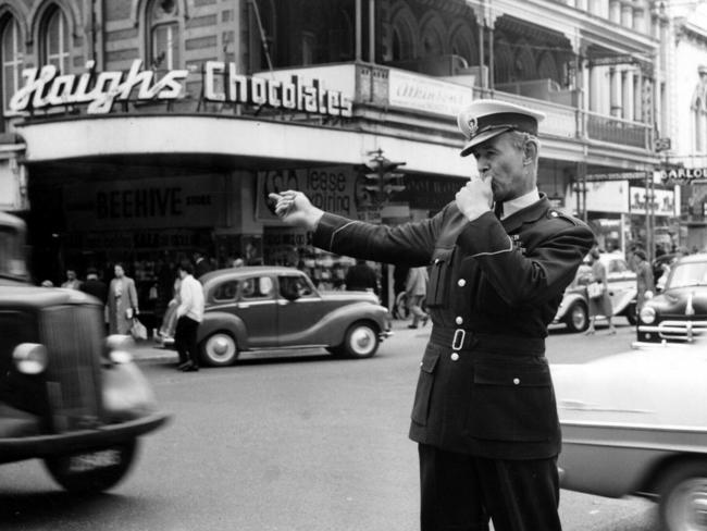 1960: A police officer directs traffic at the King William, Rundle and Hindley Street intersection in Adelaide.