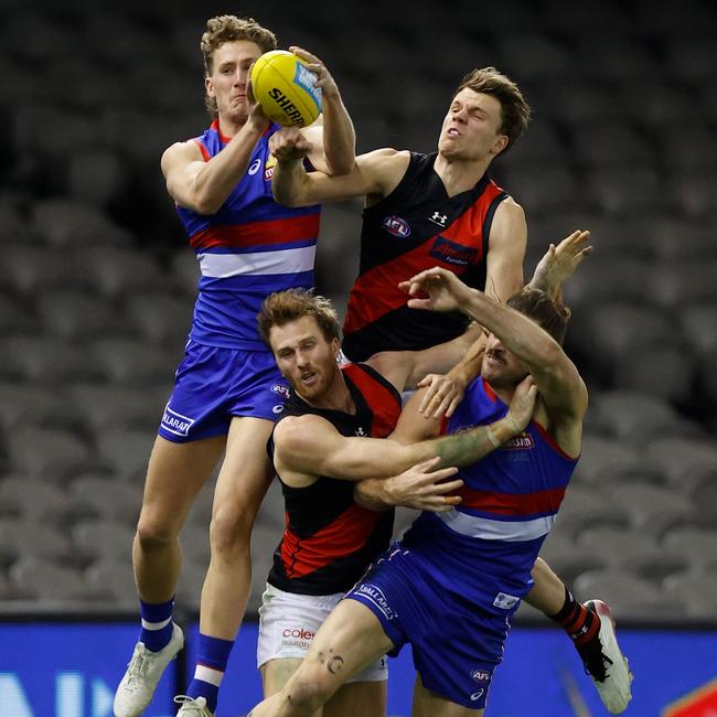 Aaron Naughton of the Bulldogs marks the ball ahead of Jordan Ridley of the Bombers during the 2021 AFL Round 21 match between the Western Bulldogs and the Essendon Bombers at Marvel Stadium on August 8, 2021 in Melbourne, Australia. (Photo by Michael Willson/AFL Photos via Getty Images)