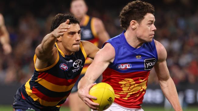 Shane McAdam tackles Lachie Neale at Adelaide Oval. Picture: James Elsby/AFL Photos via Getty Images