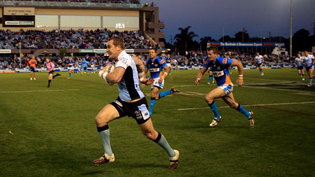 Chloe’s dad, Luke Covell, takes a run with the ball in one of his 153 NRL games for the Cronulla Sharks. Picture: Mark Evans