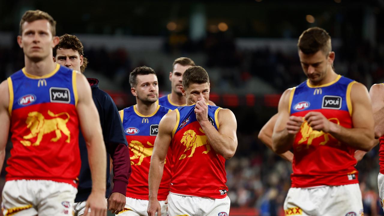 Dayne Zorko (centre) and his Lions teammates reflect on their loss to Melbourne. Picture: Michael Willson/AFL Photos via Getty Images