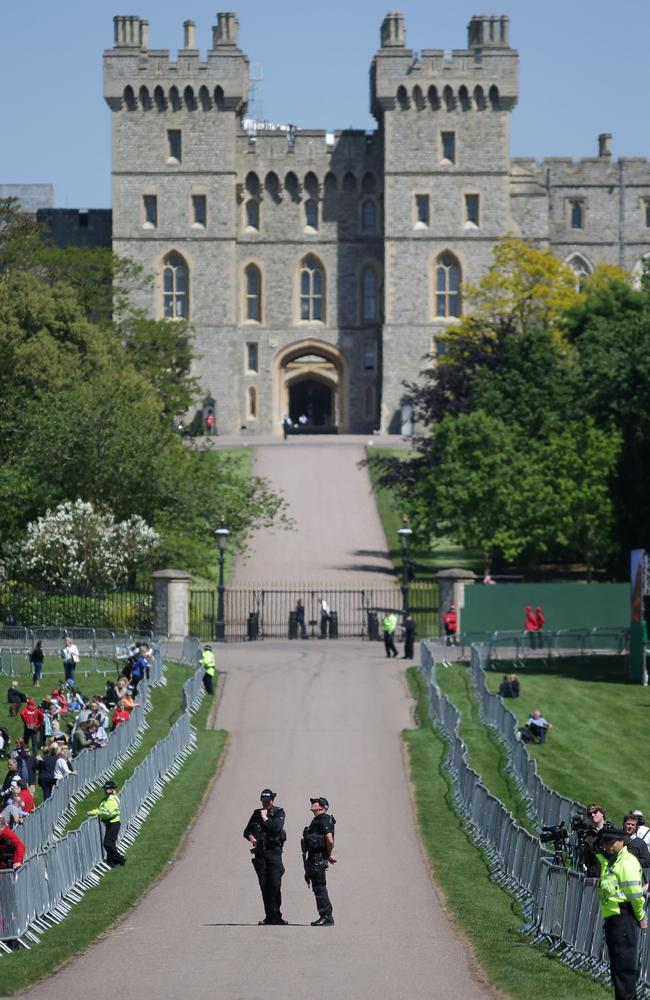 Members of the police force stand outside Cambridge Gate prior to a rehearsal for the wedding procession outside Windsor Castle in Windsor. Picture: AFP
