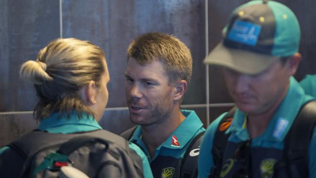 David Warner arrives with teammates, at the Cape Town International airport.