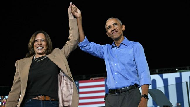 Former US President Barack Obama holds hands with US Vice President and Democratic presidential candidate Kamala Harris during a campaign in Georgia on October 24. Picture: Drew Angerer/AFP