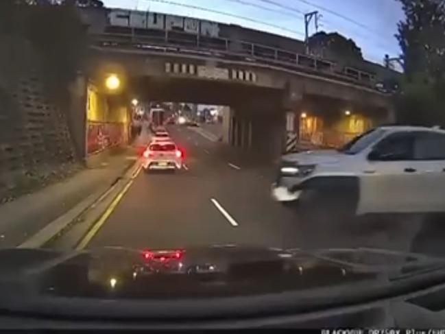 This still from video footage shows the white vehicle that was shot at trying desperately to escape, even crossing over the median strip on Woodville Rd before heading back to Church St.