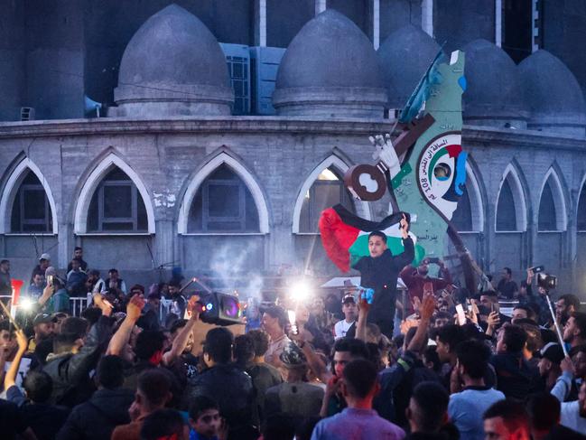 Palestinians celebrate in a street in Rafah, in the southern Gaza Strip, after Hamas announced it has accepted a truce proposal, but Israel responded with 30 minutes of intense shelling. Picture: AFP