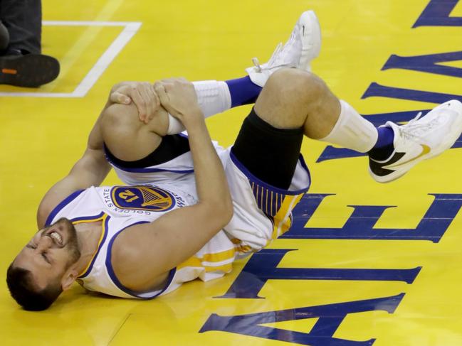 OAKLAND, CA - JUNE 13: Andrew Bogut #12 of the Golden State Warriors holds his knee in pain after sustaining an injury during the third quarter against the Cleveland Cavaliers in Game 5 of the 2016 NBA Finals at ORACLE Arena on June 13, 2016 in Oakland, California. NOTE TO USER: User expressly acknowledges and agrees that, by downloading and or using this photograph, User is consenting to the terms and conditions of the Getty Images License Agreement. Ronald Martinez/Getty Images/AFP == FOR NEWSPAPERS, INTERNET, TELCOS & TELEVISION USE ONLY ==