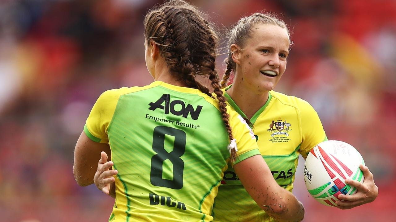 Lily Dick of Australia celebrates with teammate Emma Sykes after scoring a try.