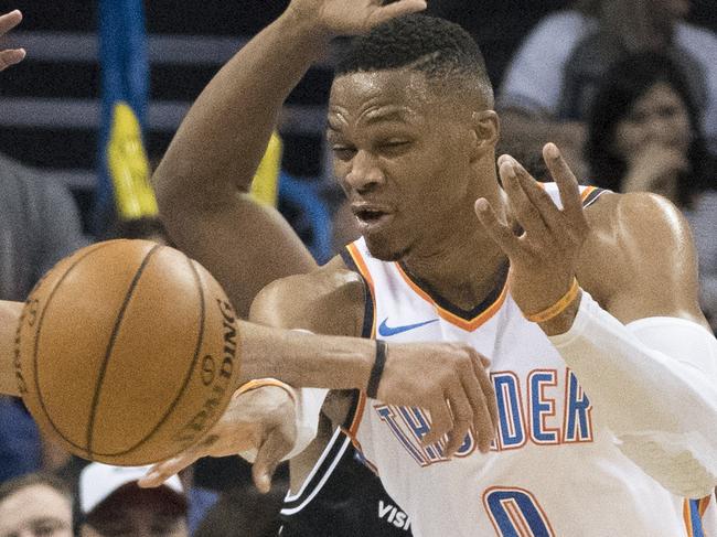 OKLAHOMA CITY, OK - OCTOBER 8: Tai Wesley #42 of the Melbourne United forces Russell Westbrook #0 of the Oklahoma City Thunder to pass the ball during the second half of a NBA preseason game at the Chesapeake Energy Arena on   October 8, 2017 in Oklahoma City, Oklahoma. NOTE TO USER: User expressly acknowledges and agrees that, by downloading and or using this photograph, User is consenting to the terms and conditions of the Getty Images License Agreement. (Photo by J Pat Carter/Getty Images)