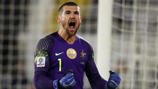 AL AIN, UNITED ARAB EMIRATES - JANUARY 21: Mat Ryan of Australia celebrates after saving the fourth penalty from Marat Bikmaev of Uzbekistan (not pictured) in the penalty shoot out during the AFC Asian Cup round of 16 match between Australia and Uzbekistan at Khalifa Bin Zayed Stadium on January 21, 2019 in Al Ain, United Arab Emirates. (Photo by Francois Nel/Getty Images)