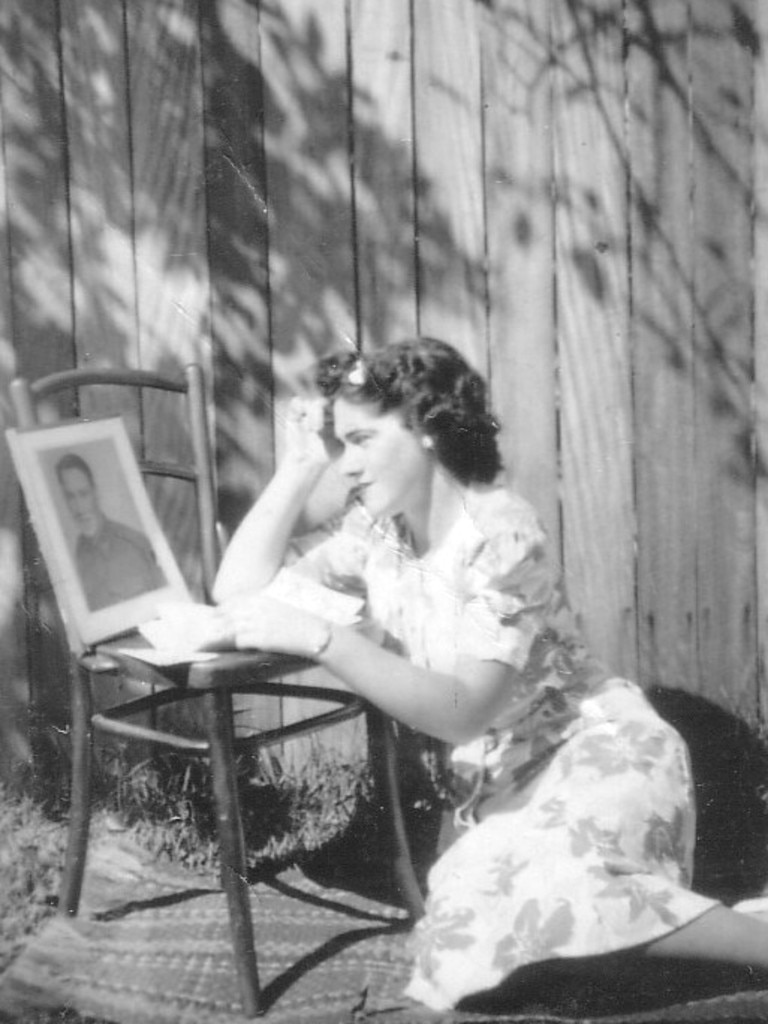 “A photo of my mother, Noreen Scott, in her backyard at Ashfield reading the latest letter from my Dad, Kevin Neylan, on service while they were engaged in 1943.” Picture: Supplied by Adrian Neylan