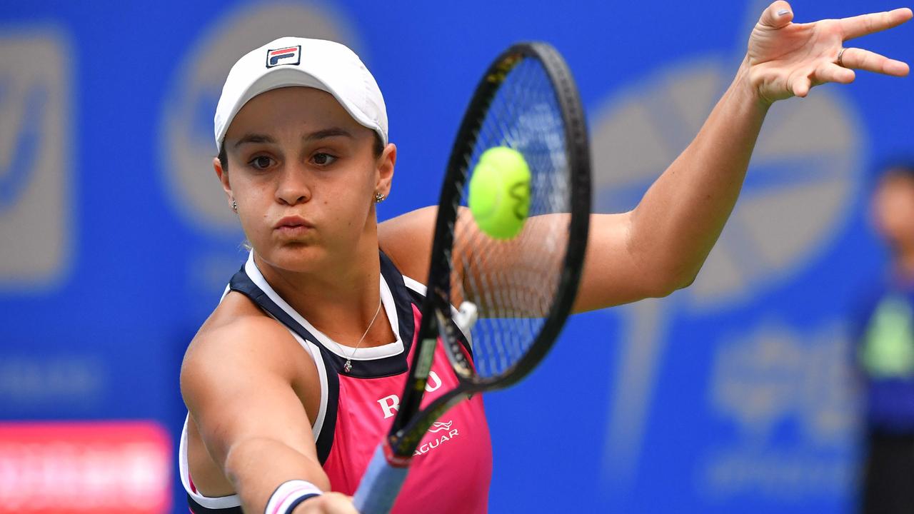 Ashleigh Bartyhits a backhand return to Petra Martic.