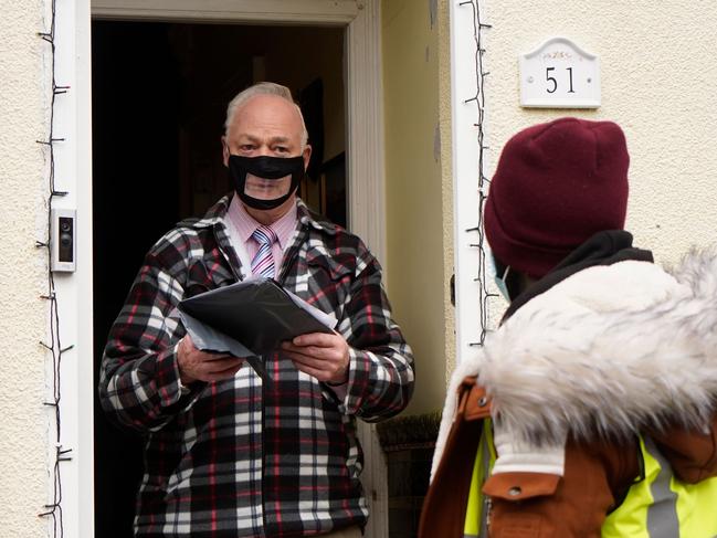 Volunteers hand-deliver COVID-19 test kits to homes in London. Picture: AFP