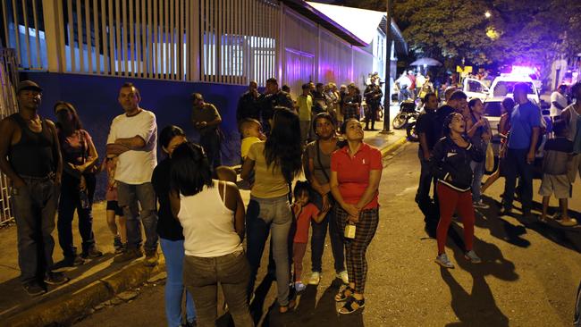 Residents stand outside their apartments as some look up at the "Tower of David" skyscraper, which suffered an inclination after a powerful earthquake shook eastern Venezuela. Picture: AP