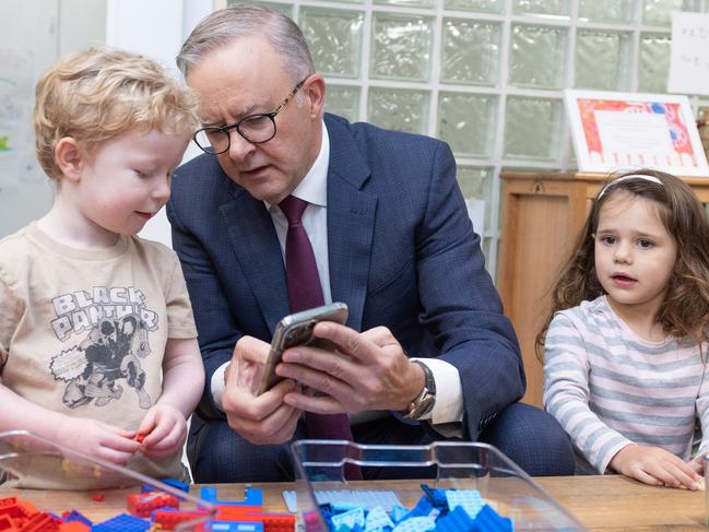 CANBERRA, AUSTRALIA - NewsWire Photos FEBRUARY 9, 2023: L-R: Bradley Gosper, Prime Minister, Anthony Albanese and Olivia Castrisson. The PM was showing Bradley his dog on his phone.Prime Minister, Anthony Albanese with the Minister for Education, Jason Clare, the Minister for Early Childhood Education, Dr Anne Aly and Alicia Payne, the Member for Canberra during a visit to the Manuka Childcare Centre.Picture: NCA NewsWire / Gary Ramage