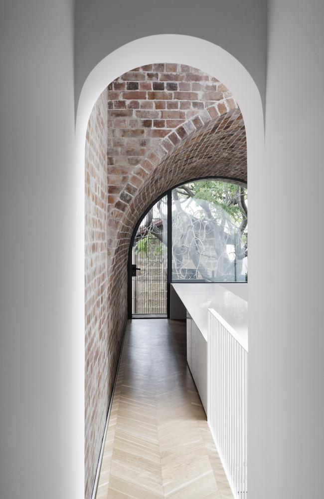 This extension to a terrace house designed by architect Renato D’Ettorre breaks up a long hallway with a classic brick archway.