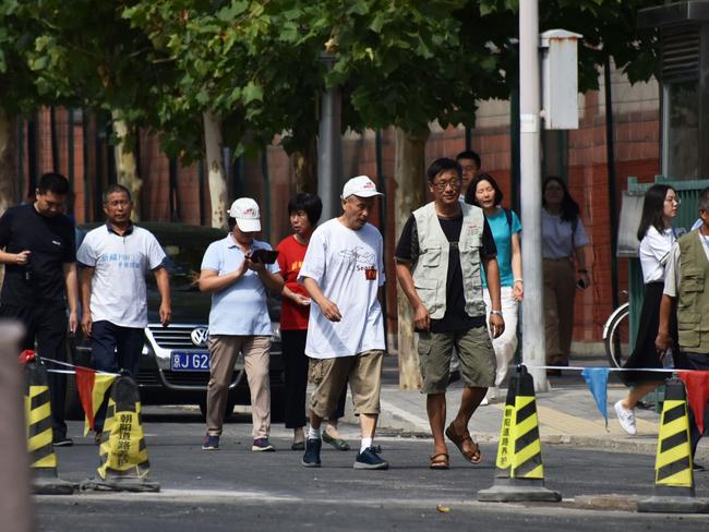 Relatives of passengers aboard the missing Malaysia Airlines flight MH370 walk out after delivering a letter to the Malaysian embassy in Beijing in August. Picture: AFP