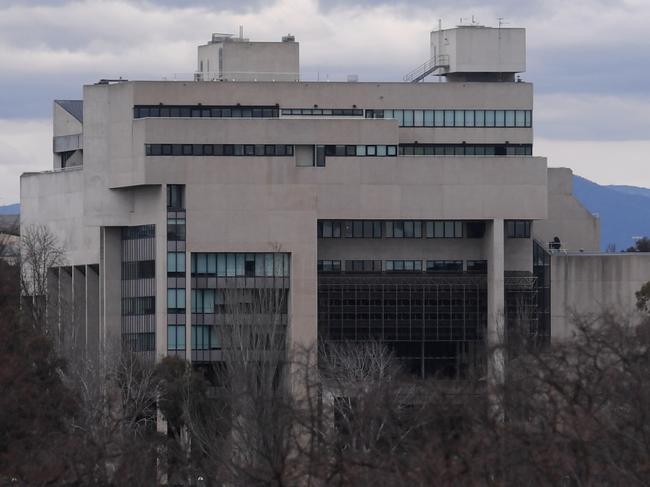 Parliament House is seen next to the High Court building on the shore of Lake Burley Griffin in Canberra, Monday, August 21, 2017. The High Court has been asked by Parliament to rule on the issue of citizenship under Section 44 regarding several federal politicians.  (AAP Image/Lukas Coch) NO ARCHIVING