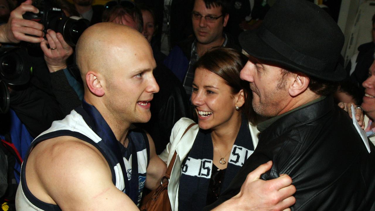 Gary Ablett Jr and his father Gary Ablett Sr embrace.