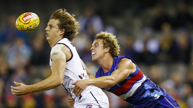 AFL Round 11: Western Bulldogs v Fremantle at Etihad Stadium. Nat Fyfe tries to take possession with Mitch Wallis close by. Pic: Michael Klein. Saturday May 31, 2014.