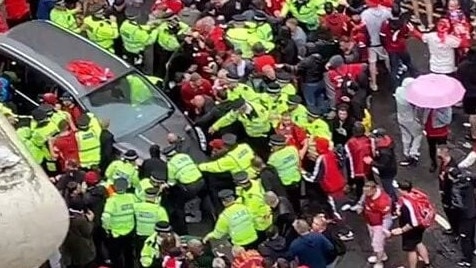 The car is surrounded by police and football fans. Picture: Supplied