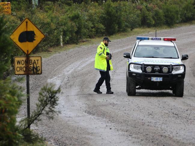 Tasmania Police at a road block at Henty Gold Mine in Tasmania's west where a man is believed to be missing following a rock fall. Picture: GRANT WELLS