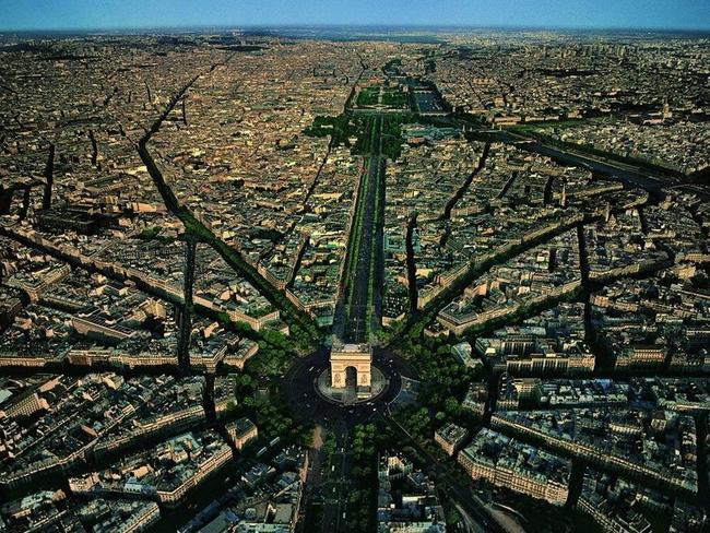 Looking down the Champs-Elysees, the Arc de Triomphe stands at the centre of 12 radiating avenues.