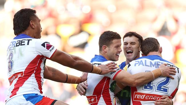 BRISBANE, AUSTRALIA - MAY 18: David Armstrong of the Knights celebrates with his team mates after scoring a try during the round 11 NRL match between Gold Coast Titans and Newcastle Knights at Suncorp Stadium, on May 18, 2024, in Brisbane, Australia. (Photo by Hannah Peters/Getty Images)